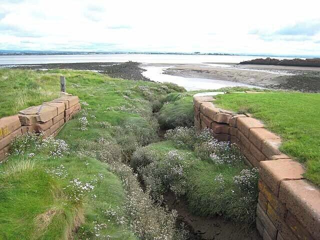 Old sea lock on the Carlisle Canal Port Carlisle was constructed in the 19th century to provide a deep-water port for Carlisle. A canal was constructed from here to Carlisle, completed in 1823, but was closed after only 30 years. The port did not flourish and is now just a ruin. The Scottish shore can be seen on the far side of the Solway Firth.