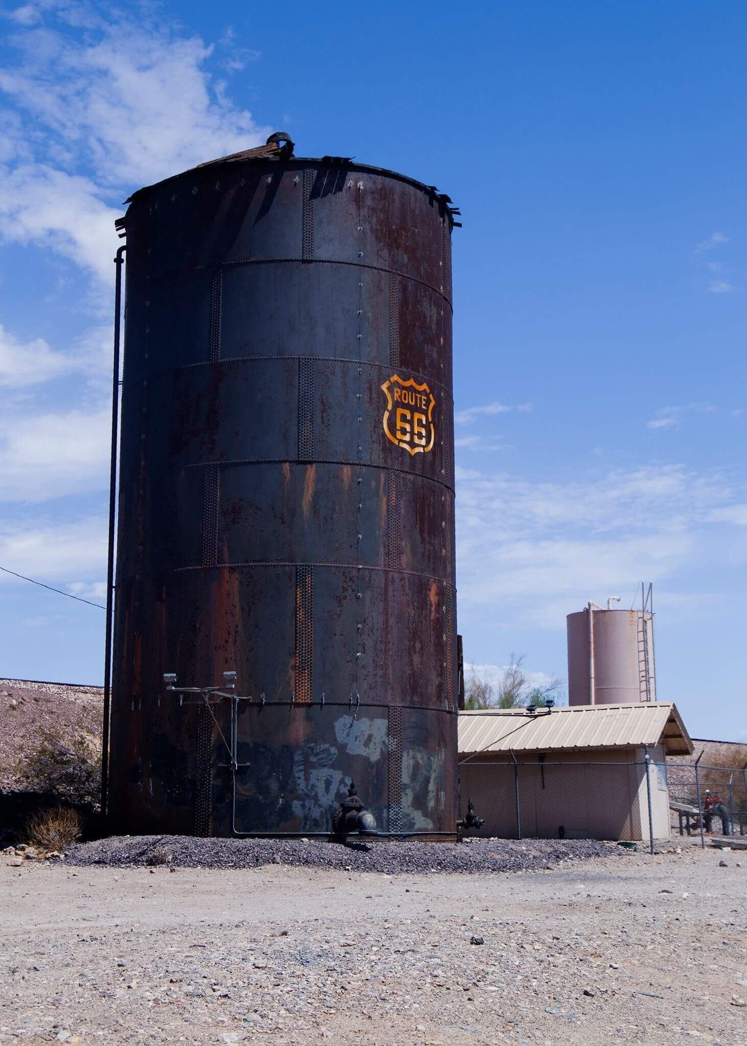 Old busted water tower on the side of the road 