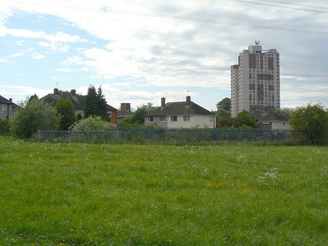 The back of houses on Farnborough Road. The pair of houses to the left of the picture (largely hidden by trees) will be demolished to make way for the proposed tram route to Clifton which will pass just to the right of the camera position.. Prominent is the Southchurch Court tower block.