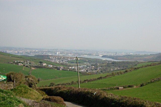 Hillside above Millbrook Taken from the roadside by Whitsands Bay Holiday Park, this shot looks across the pasture fields of this square and beyond to Millbrook and Plymouth. Behind the photographer are the cliffs of Whitsands Bay.