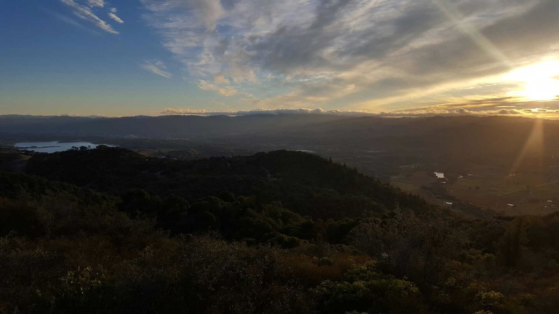 A mountainous landscape with a valley and a lake.