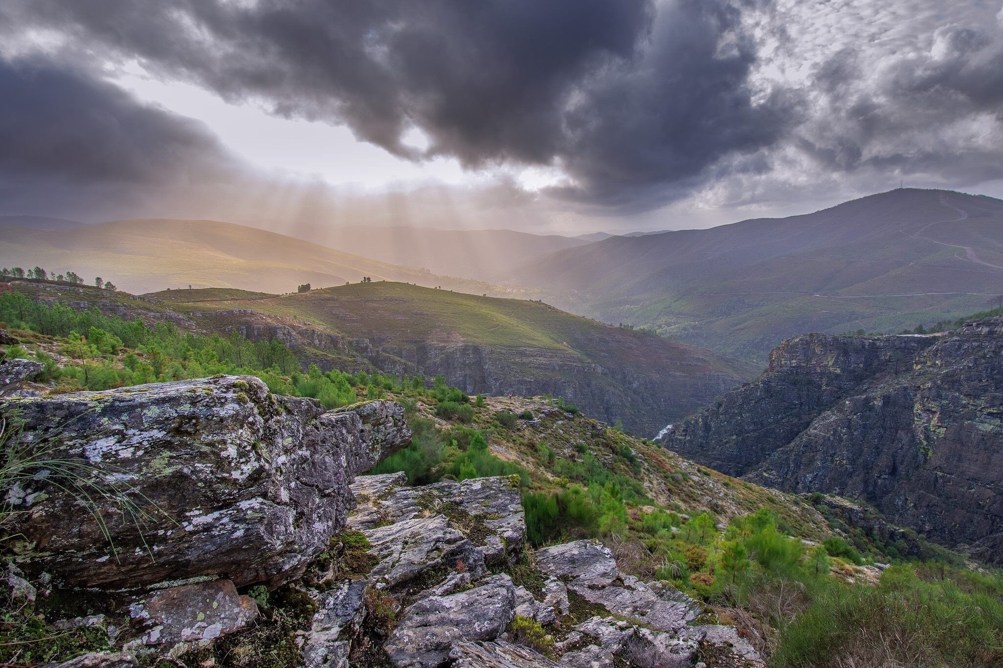 A mountainous landscape with rocky terrain and a winding path.