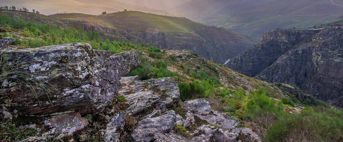 A mountainous landscape with rocky terrain and a winding path.
