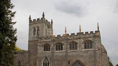 A historic stone church with a tall tower and arched windows.