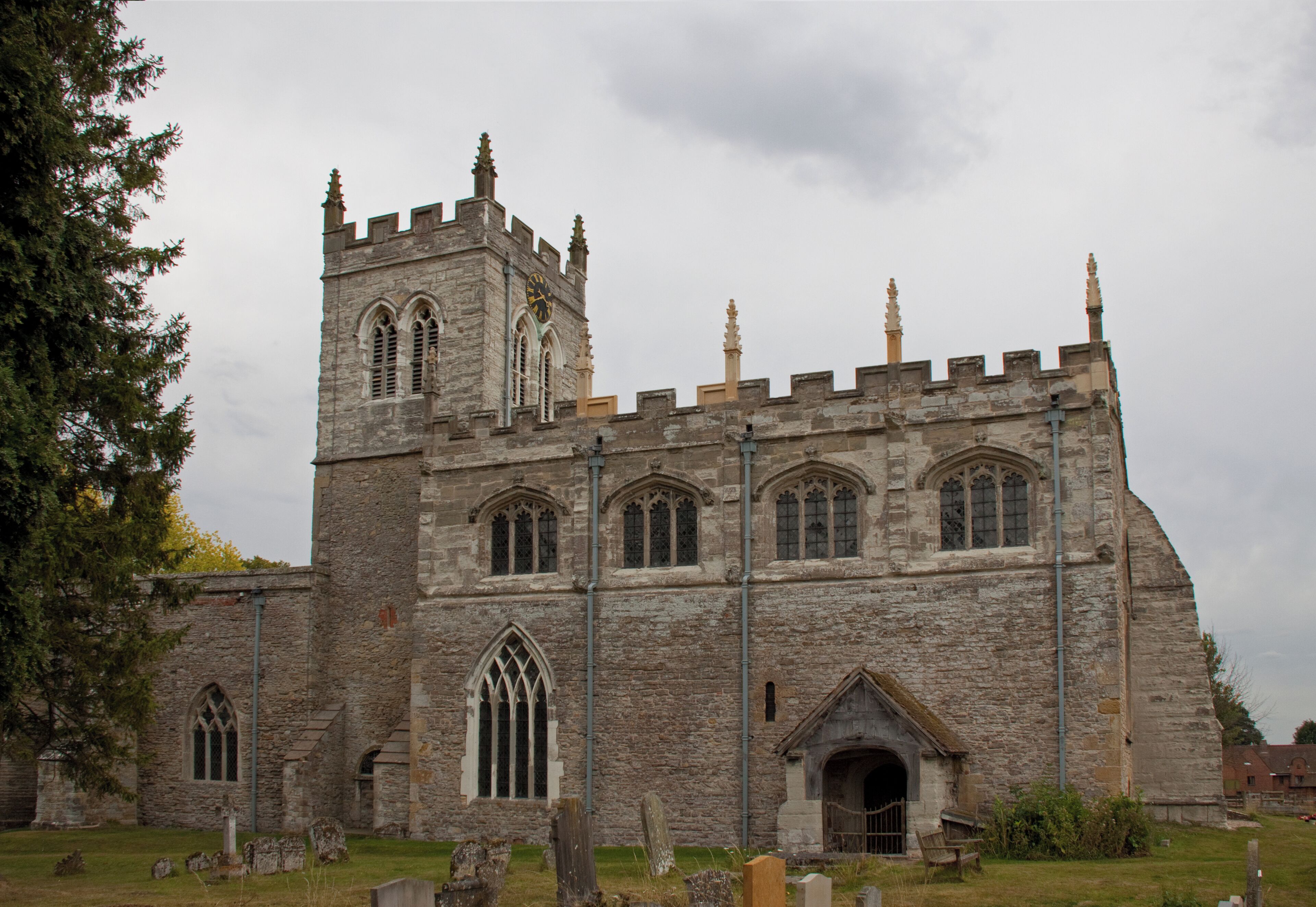 A historic stone church with a tall tower and arched windows.