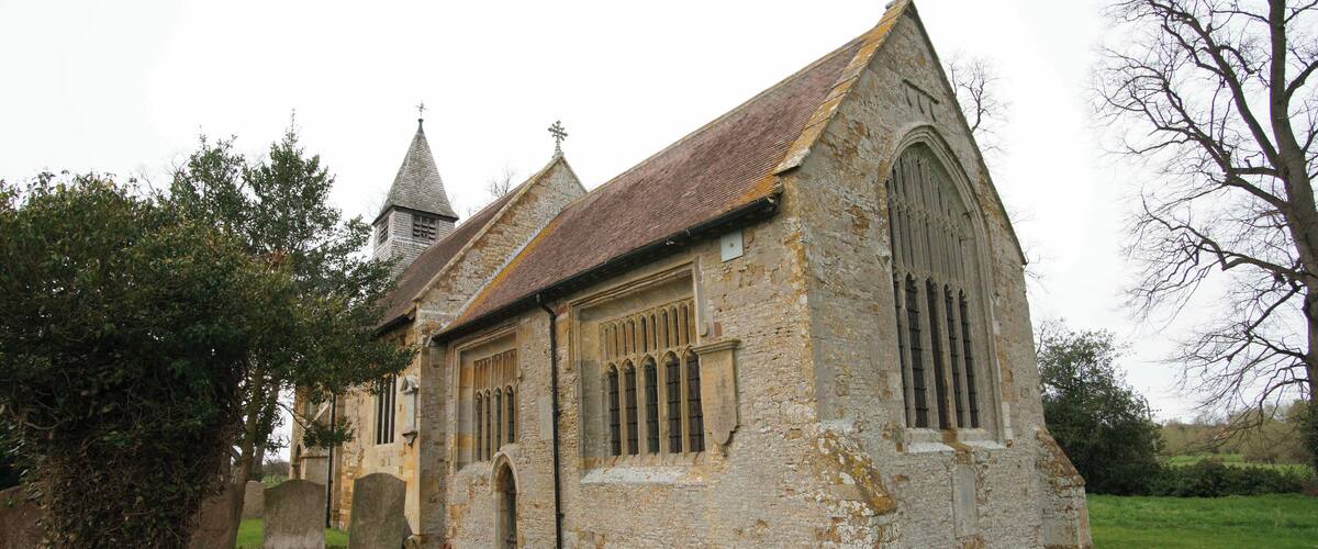 A historic church with a pointed roof and arched windows.
