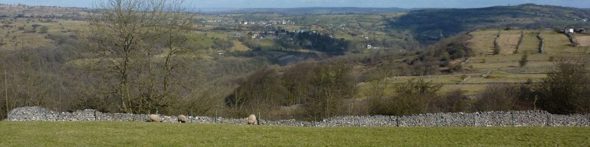 View from a track west of Middleton by Wirksworth Looking north; the village in the distance is Bonsall. Strip fields can be seen in middle distance, right. Middleton was a farming community, long before the arrival of the quarries.Just to the left of the strip fields, the chimney of Arkwright's Masson Mill can be seen ( at SK 294 573 )