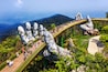 Top aerial view of the famous Golden Bridge is lifted by two giant hands in the tourist resort on Ba Na Hill in Da Nang, Vietnam. Cau Vang is a favorite destination for tourists , Shutterstock ID 13