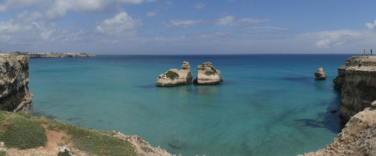 The Two Sisters are two stacks in turquoise water of Torre dell'Orso beach and generated by wind erosion.