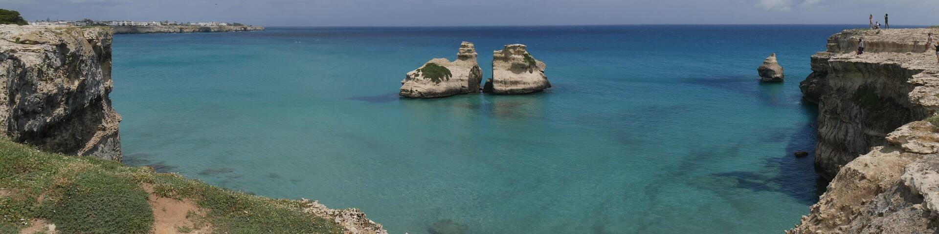 The Two Sisters are two stacks in turquoise water of Torre dell'Orso beach and generated by wind erosion.