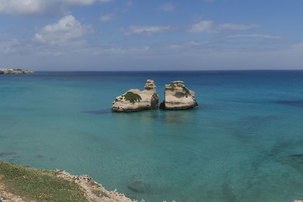 The Two Sisters are two stacks in turquoise water of Torre dell'Orso beach and generated by wind erosion.