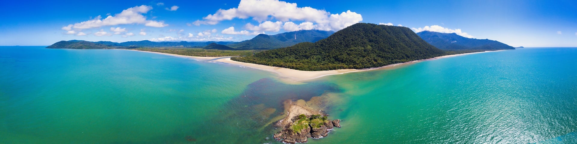 Aerial image of Thornton Beach located in the Cape Tribulation section of Daintree National Park, located in the tropical far north of Queensland, Australia.