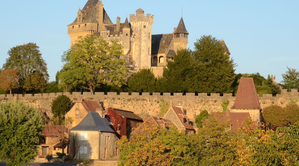 Castle Montfort high above the Dordogneriver in France, in the eveningsun glowing