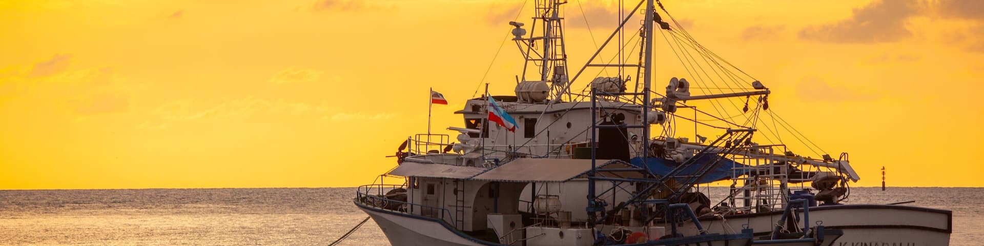 Kota Kinabalu Waterfront showing general coastal views, boating and a sunset