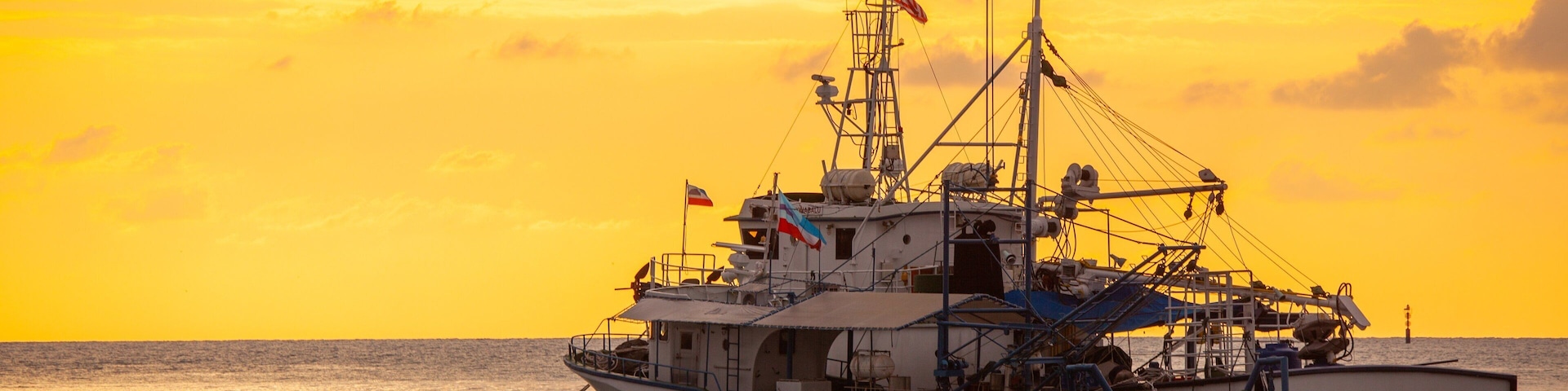 Kota Kinabalu Waterfront showing general coastal views, boating and a sunset