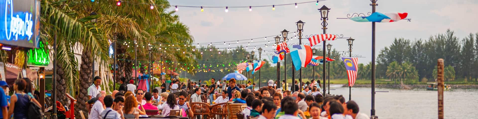 Kota Kinabalu Waterfront featuring outdoor eating as well as a large group of people