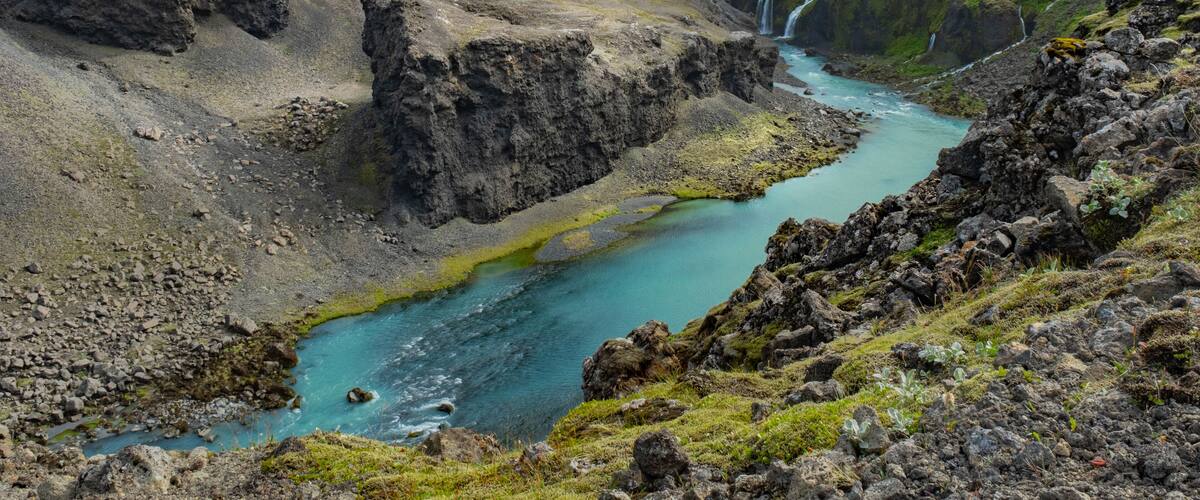 A river flowing through a rocky canyon with waterfalls.