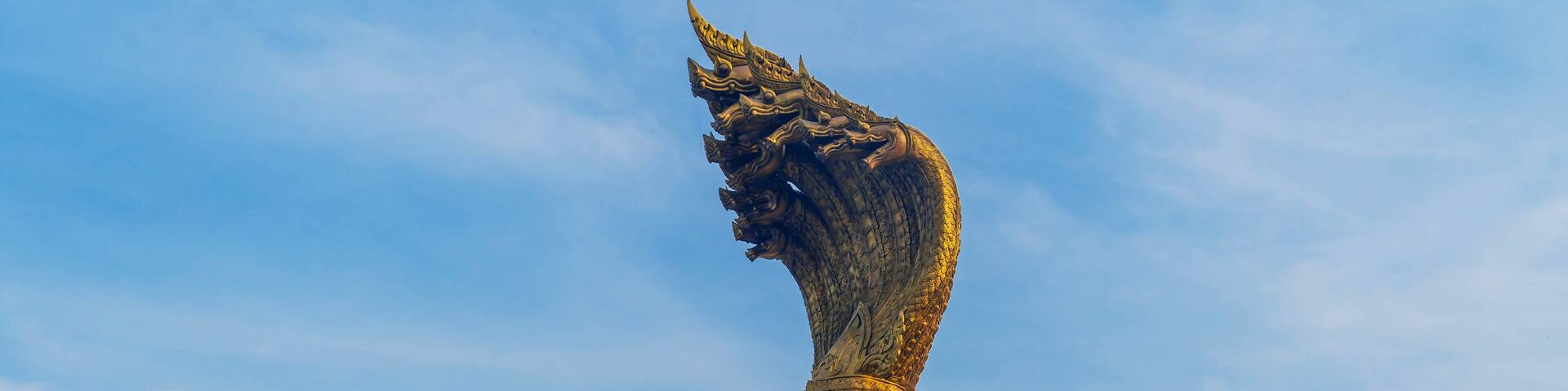 Landmarks Statue of the Naga serpent of seven heads belief in buddhism name Phraya Srisatta Nakarat at the mekong river in Nakhon Phanom, Thailand.