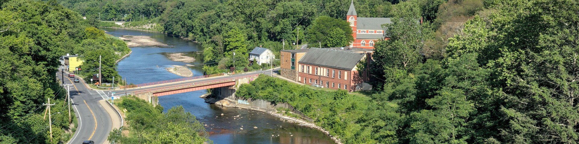 view of a bridge over the rondout creek and a small church in rosendale new york (seen from the wallkill valley rail trail) trestle crossing high falls new paltz