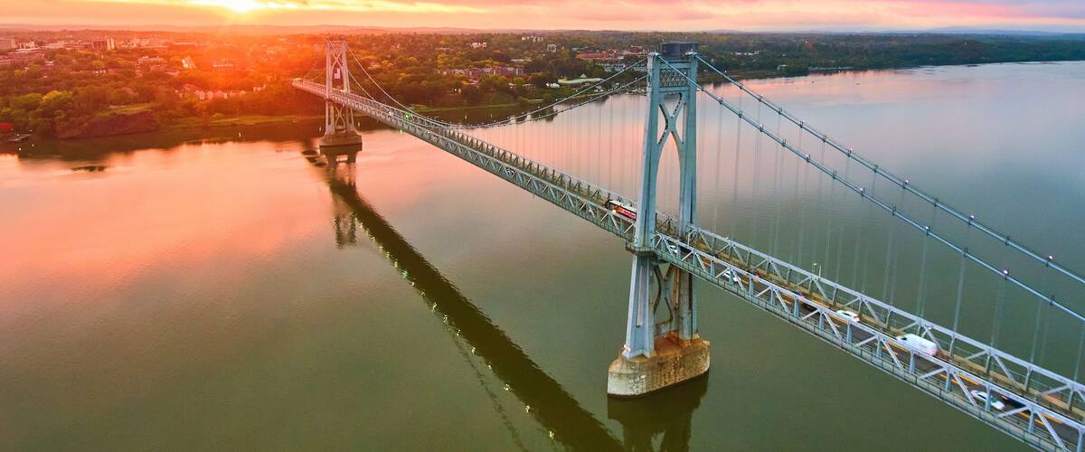 Hudson River bridge aerial with stunning pink and gold sunrise light