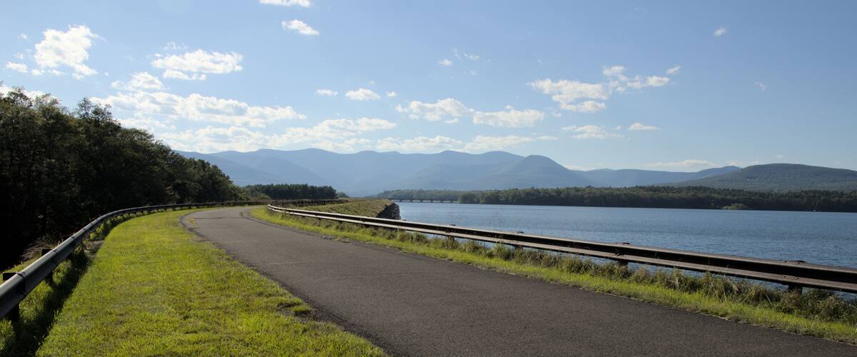 ashokan reservoir promenade surface next to large pond body of water and catskills mountains in the background (public park leisure, walking biking path trail) sunny day travel hudson valley new york