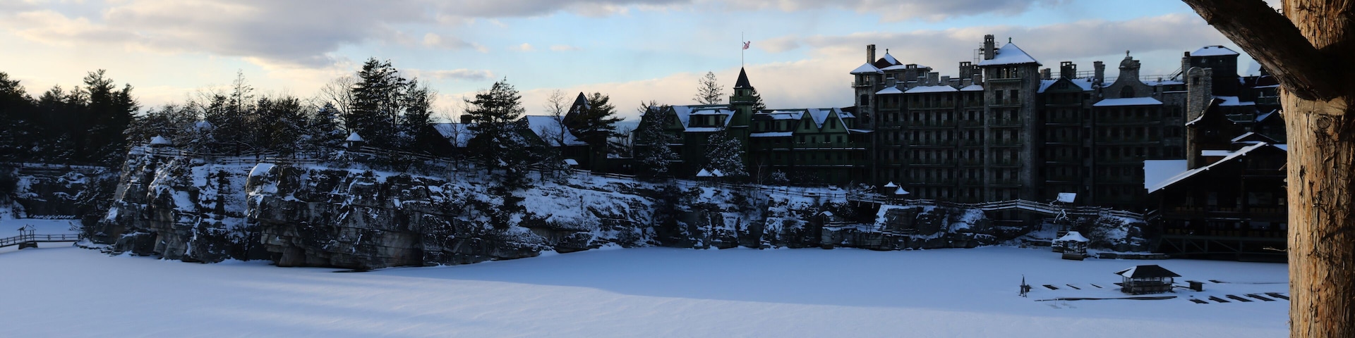 sunset view of famous hotel and wooden gazebo along hiking trail in upstate new york near new paltz (shawangunk mountain) winter snow house mohonk preserve frozen lake hike blizzard