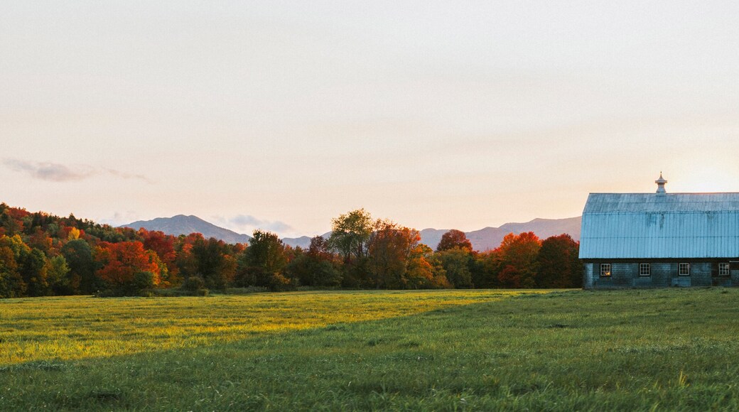 Adirondacks, NY sunset over a farm with the mountains in the background