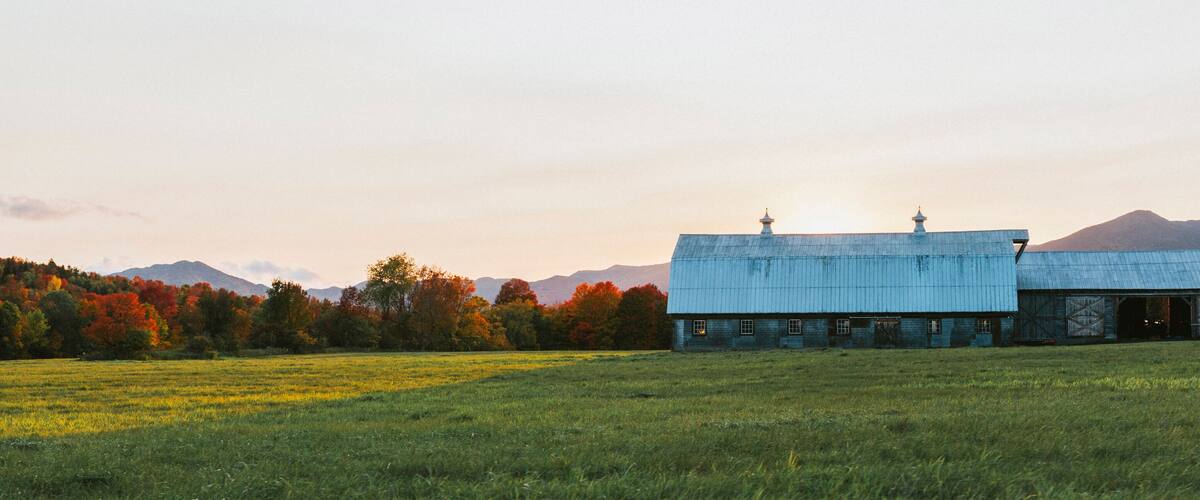 Adirondacks, NY sunset over a farm with the mountains in the background
