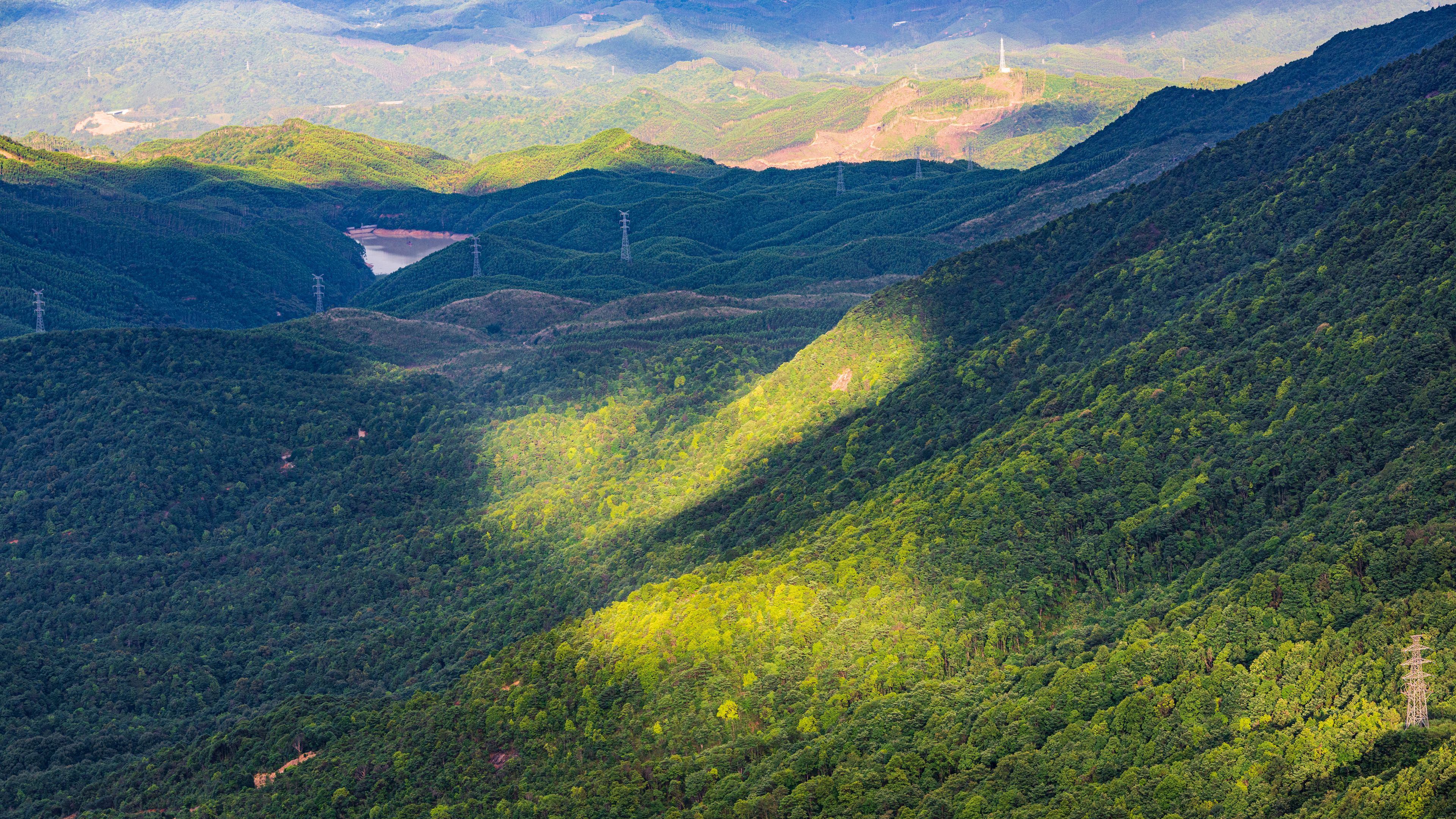 Wind turbines after a summer rain on Queya Mountain, Dongyuan County, Heyuan, Guangdong, China.