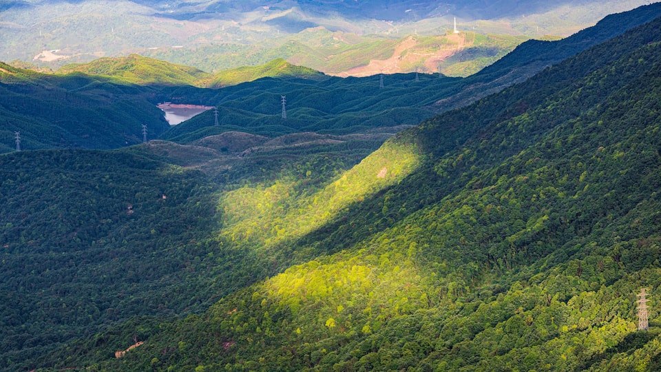 Wind turbines after a summer rain on Queya Mountain, Dongyuan County, Heyuan, Guangdong, China.