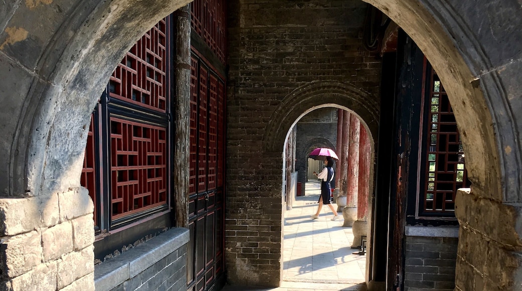 This is in an old government complex in Nanyang built in 1271. Amazingly well preserved with buildings, bronze statues, and a prison. I liked the way the woman with the umbrella walked into my frame.