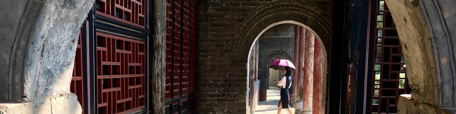 This is in an old government complex in Nanyang built in 1271. Amazingly well preserved with buildings, bronze statues, and a prison. I liked the way the woman with the umbrella walked into my frame.