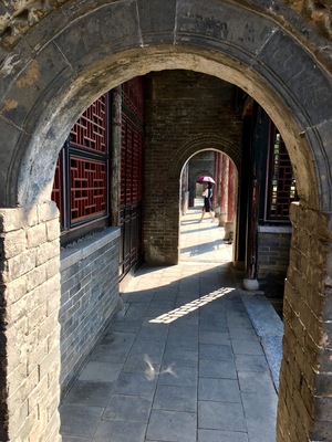 This is in an old government complex in Nanyang built in 1271. Amazingly well preserved with buildings, bronze statues, and a prison. I liked the way the woman with the umbrella walked into my frame.