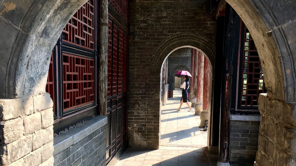 This is in an old government complex in Nanyang built in 1271. Amazingly well preserved with buildings, bronze statues, and a prison. I liked the way the woman with the umbrella walked into my frame.