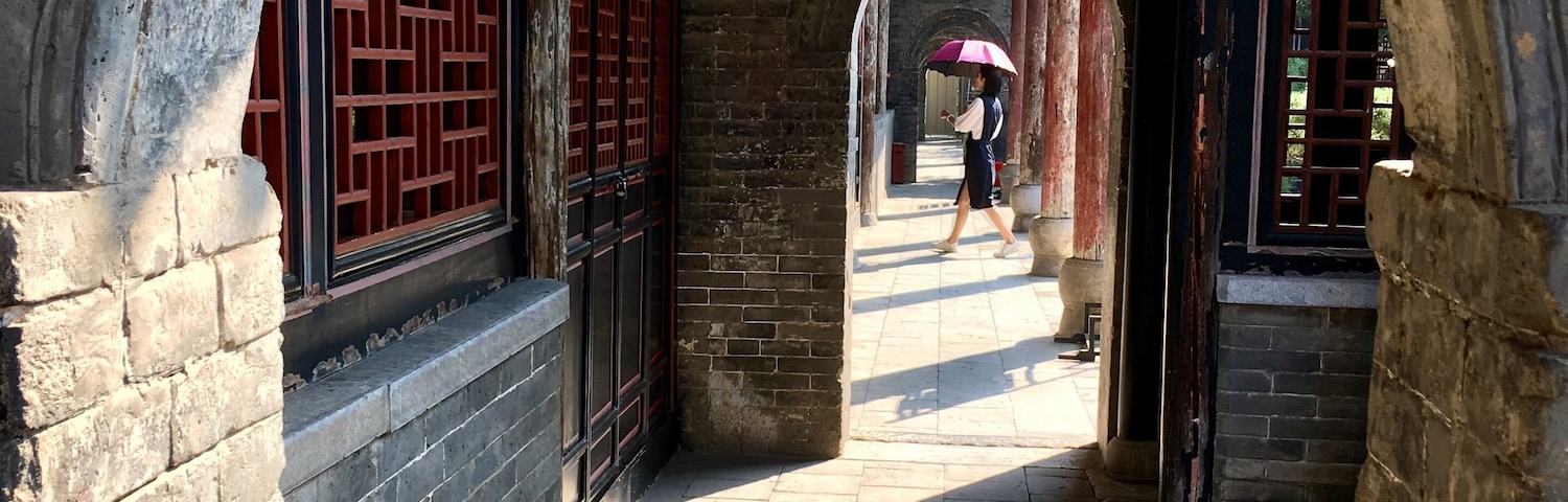 This is in an old government complex in Nanyang built in 1271. Amazingly well preserved with buildings, bronze statues, and a prison. I liked the way the woman with the umbrella walked into my frame.