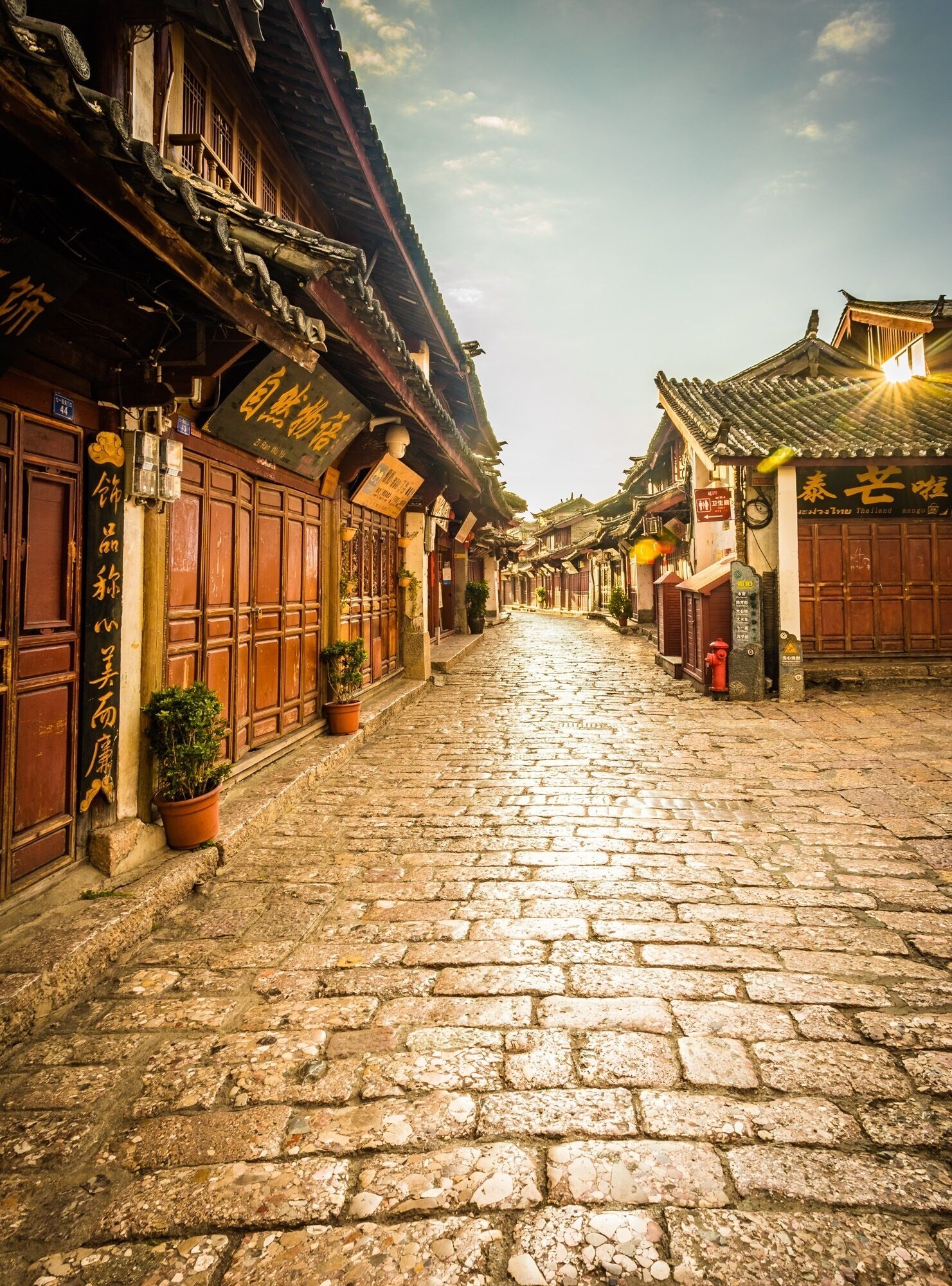 If you get up early enough, you can walk through the old ancient town of Lijiang before anyone opens a shop or steps out into the old cobbles. A true way to see this area and a great time for photos as the golden sun hits the reflecting stones.