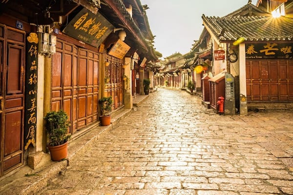 If you get up early enough, you can walk through the old ancient town of Lijiang before anyone opens a shop or steps out into the old cobbles. A true way to see this area and a great time for photos as the golden sun hits the reflecting stones.