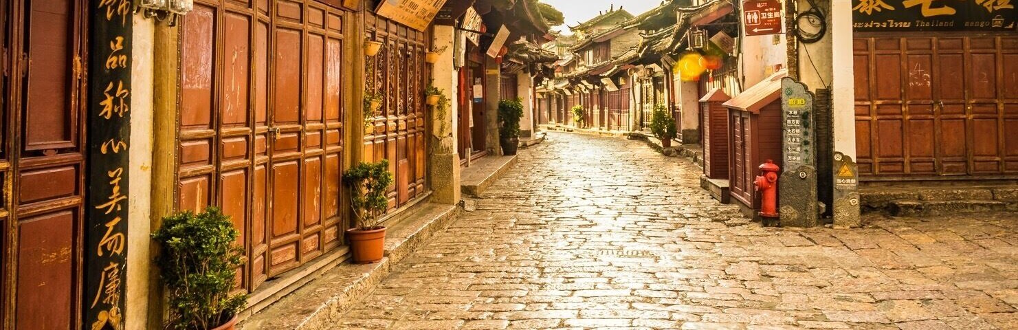 If you get up early enough, you can walk through the old ancient town of Lijiang before anyone opens a shop or steps out into the old cobbles. A true way to see this area and a great time for photos as the golden sun hits the reflecting stones.