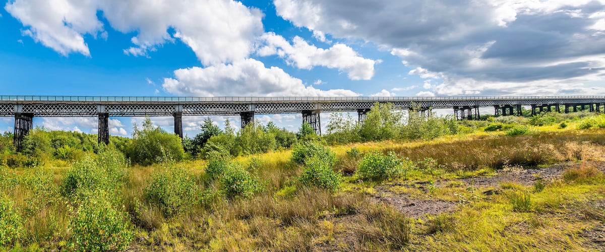 A panorama view towards the Bennerley Viaduct over the Erewash canal in summertime