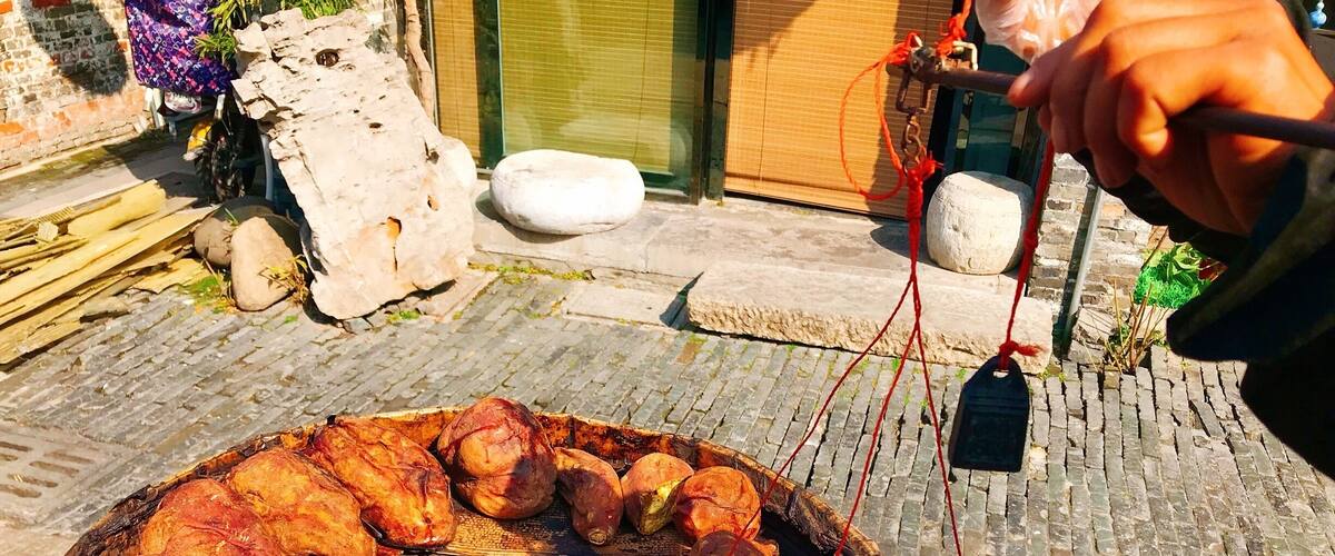 Roasted sweet potatoes on a large outdoor grill.