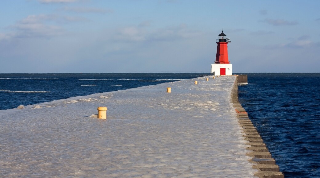 Winter landscape with lighthouse. Scenic view with lake Michigan and Menominee North Pier lighthouse in cold morning sun light. Midwest USA, state Michigan. Grate Lakes and travel America background.