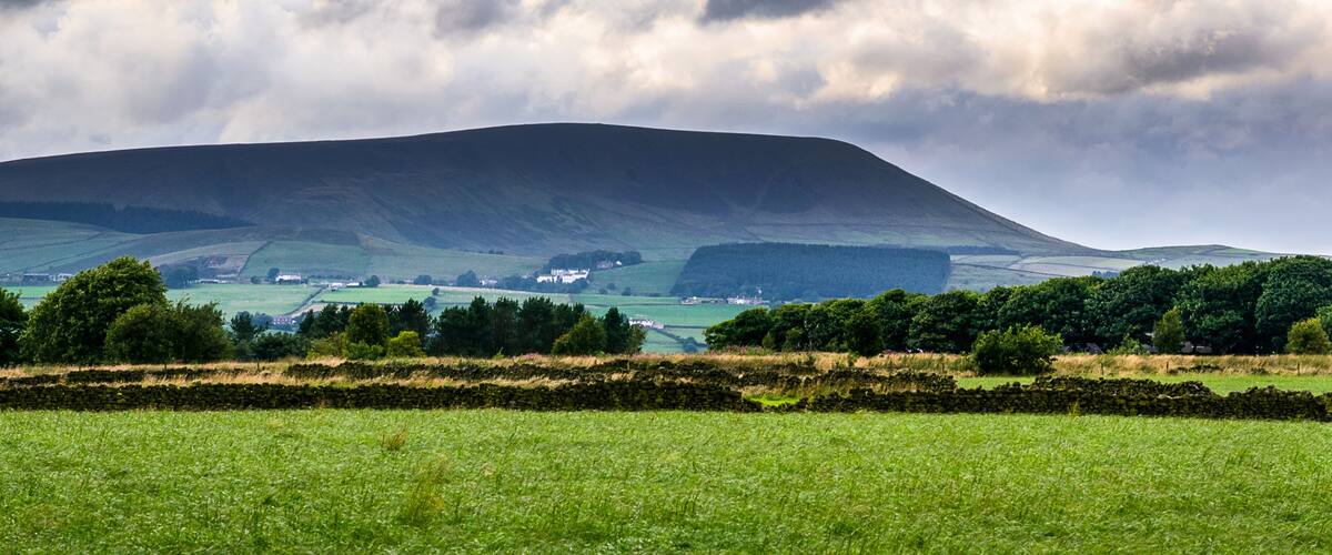 Distance view from farm on Pendle Hill on cloudy summer afternoon