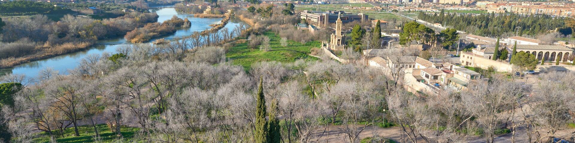 Landscape view of the Vega Baja / low valley of the city of Toledo with the Cristo de la Vega Hermitage and the Tajo / Tagus River and Polvorines bridge on the left, Castilla la Mancha, Spain