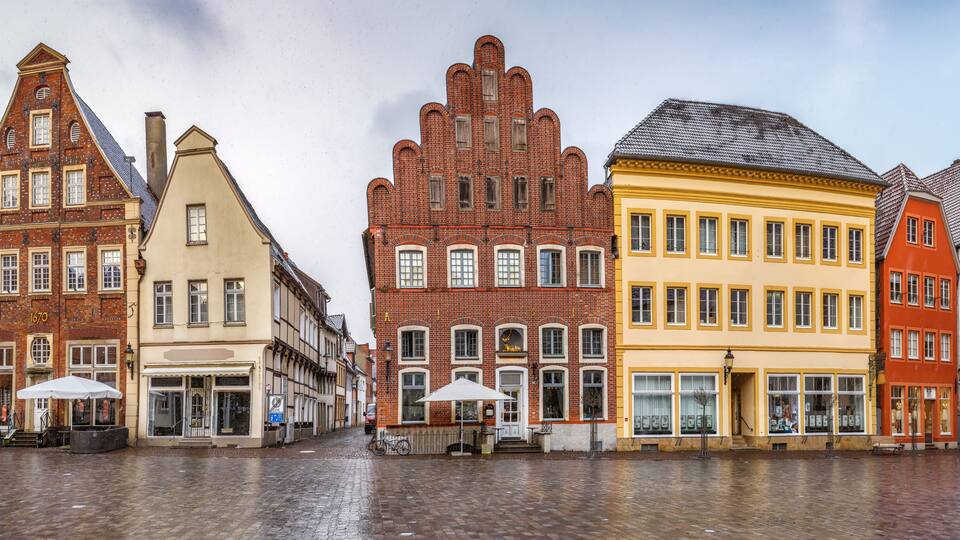 A row of colorful historic buildings with a cobblestone street.