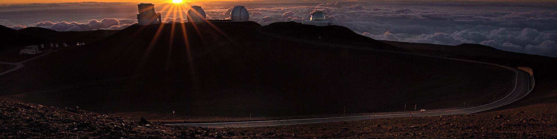The summit of Mauna Kea during sunset. Because we are so high the sun actually sets into the clouds below.