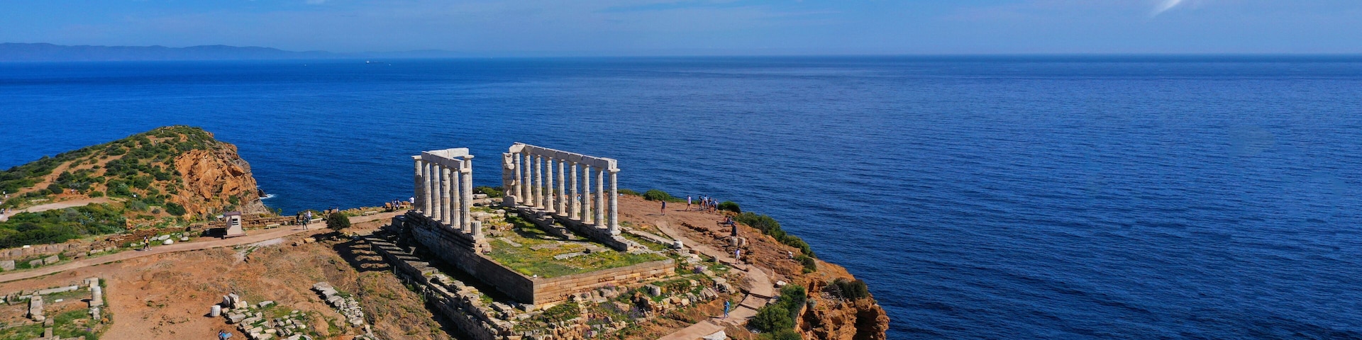 Aerial drone ultra wide photo of iconic Temple of Poseidon in Southern part of Attica, Cape Sounion, Greece