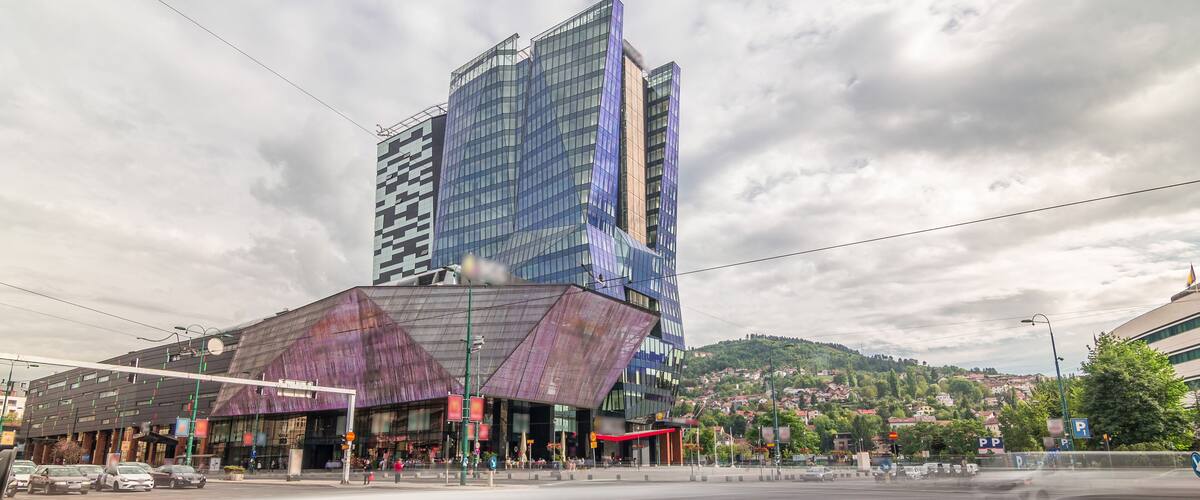 Skyscrapers and shopping mall with large luminous screen in Sarajevo City Center timelapse hyperlapse