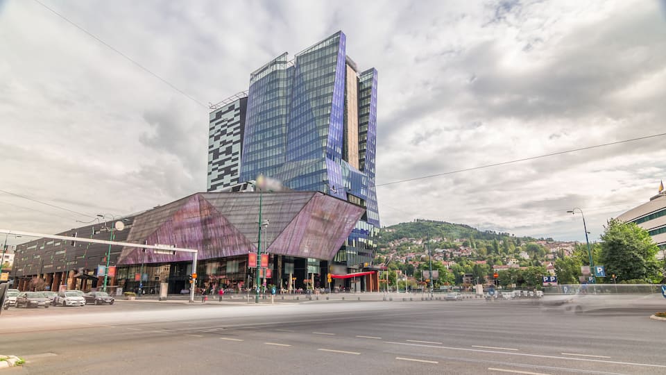 Skyscrapers and shopping mall with large luminous screen in Sarajevo City Center timelapse hyperlapse