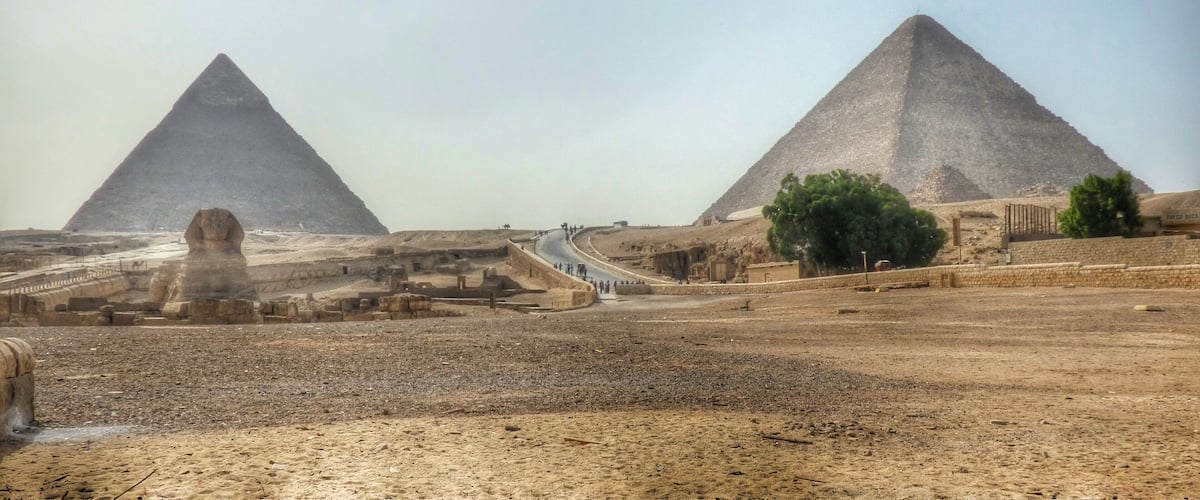The Great Pyramids of Giza, the Sphinx, and a desert landscape.