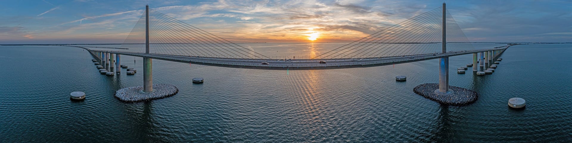 Drone panorama of Sunshine Skyway Bridge over Tampa Bay at sunset